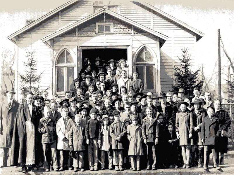 crowd standing in front of a church